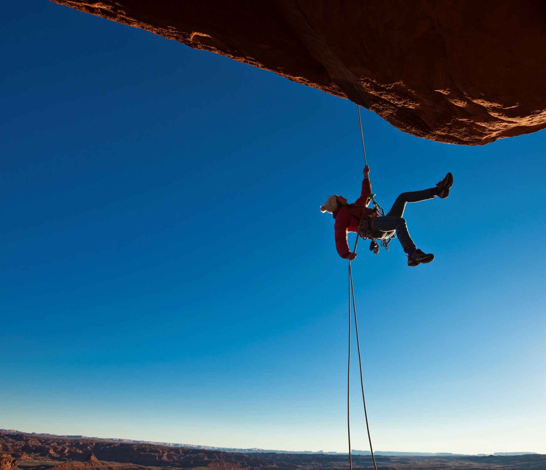 Rock climber rappelling.